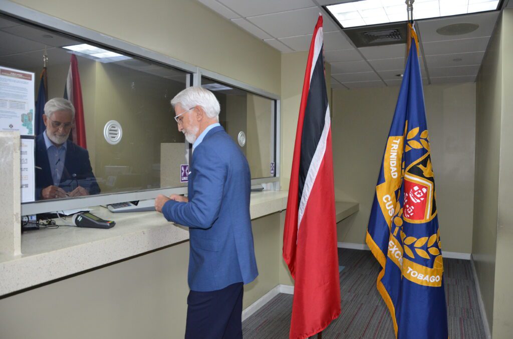 CEO of Caribbean Lifts Ltd. Mr. Gregory Farah performs the first Point of Sale Transaction at Custom House POS