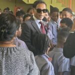 Minister Padarath reads to children at California Government Primary